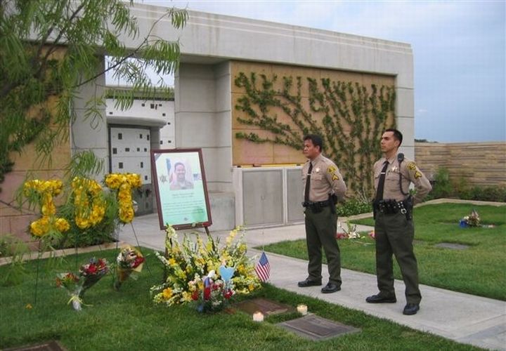 Deputies Joe Nanquil and Jorge Chavez of the Los Angeles County Sheriff’s Department conduct a graveside vigil in honor of Dep. Mike Arruda on the fifth anniversary of his death.