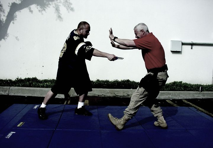 Present the least vulnerable target. If you are under fire, you find cover. The same principle applies here. If you are physically attacked, you move, you angle, you put something between you and the attack (in this case, most likely your arms).