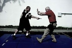 Present the least vulnerable target. If you are under fire, you find cover. The same principle applies here. If you are physically attacked, you move, you angle, you put something between you and the attack (in this case, most likely your arms).