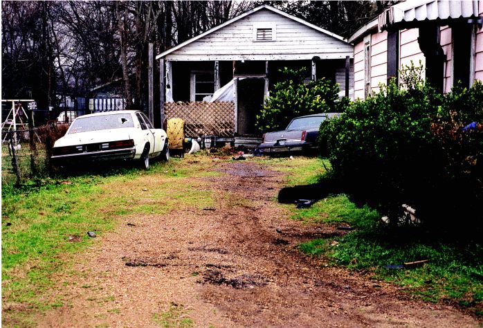 Alexandria’s SRT team fought a pitched battle on this property. Gas drove the gunman from the white house, and he was killed in an exchange of gunfire. His body has been marked out of photo.