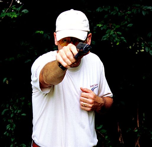 The conventional one-hand shooting method is to step toward the target and cant the gun inward.