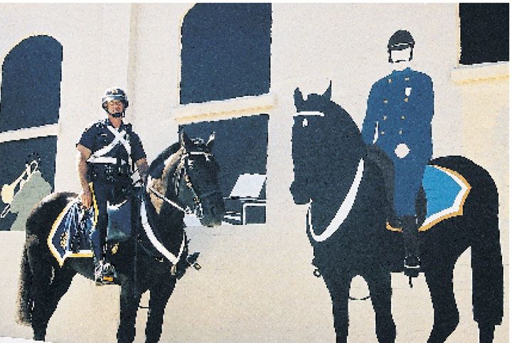 Sgt. Roland Morin and his horse King Arthur stand near a downtown mural of a turn-of-the-century Dover police officer. The mounted unit is again an important part of Dover’s patrol division.