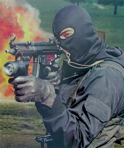 A member of the Italian “GIS” armed with the 9mm H&K MP5 SMG. Note the special flashlight/foregrip combination used on this specific weapon.