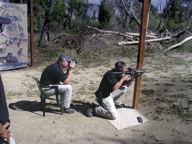Sgt. David McDonald of the Raleigh Police Department competes in the rifle stage of the 5.11 Challenge as teammate Sgt. Robert Windsor of the Wake County Sheriff’s Department spots.