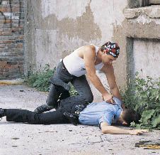 If you don’t watch your back, a suspect just might put a bullet in it.