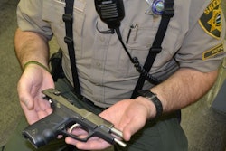 Deputy Aaron West with a Ruger 9mm recovered from an eighth grader at Jefferson Middle School. Photo courtesy of MCSO.