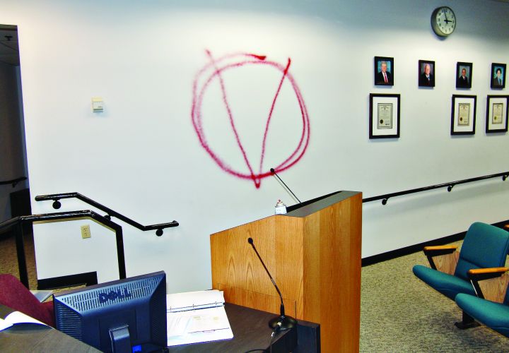 Clay A. Duke spray painted 'V for Vendetta' before opening fire.