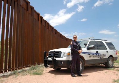 Nogales (Ariz.) Police Chief Jeffrey Kirkham near the border fence in his jurisdiction in 2010. Photo: Paul Clinton.