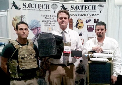 (From l. to r.) S.O. Tech's Lead Sales Rep Neil Trusso, CEO Jim Cragg, and DynGlobal's Solar Engineer Rob Hill. Cragg is holding the vest-mounted solar panel and a battery. Hill is holding a representation of a solar-power and water filtration system. Photo: S.O. Tech