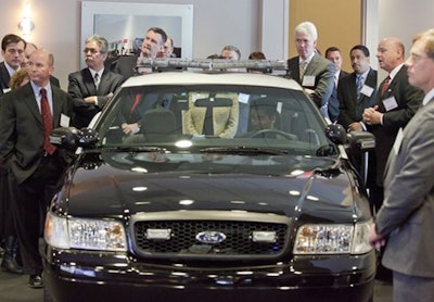 Raytheon executives and guests watch a video feed provided by a cruiser-mounted camera. Photo: Raytheon