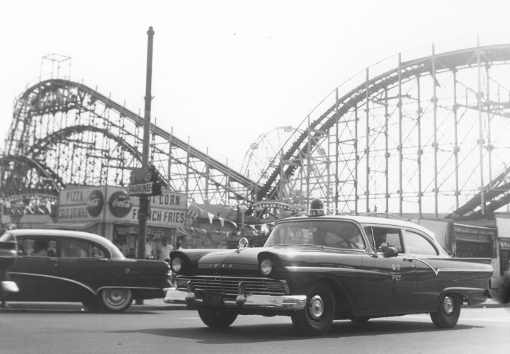 In the 1950s, the NYPD used Ford RMPs (Radio Motor Patrol). This photo shows one at Coney Island in 1956. Note the passenger-side only spotlight.