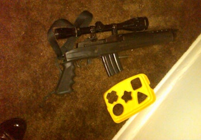 A sawed-off assault rifle lays next to a children's toy after a suspect's gunfight with officers. Photo: NYPD