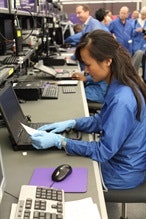 A FedEx TechConnect technician makes a warranty repair to a Getac ruggedized notebook.