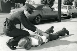 A female police officer makes an arrest in the 1980s. Photo courtesy of Los Angeles Police Historical Society.
