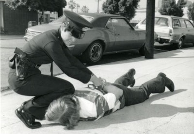 A female police officer makes an arrest in the 1980s. Photo courtesy of Los Angeles Police Historical Society.