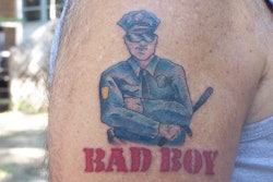 This officer's 'Bad Boy' tattoo references Inner Circle's 'Cops' theme song.