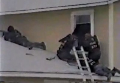 ATF agents fire guns and break into windows at the Mount Carmel Ranch compound on Feb. 28, 1993. This screenshot is from footage that appears in Linda Thompson's 'Waco: The Big Lie.'