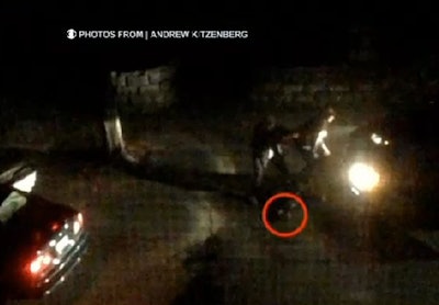 Boston Marathon bomber suspects engage police with an pressure-cooker IED (in red circle). Photo by Andrew Kitzenberg.