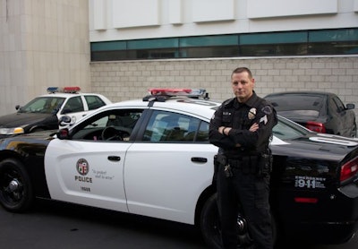 LAPD Sgt. Joel Miller poses next to an LAPD Dodge Charger Pursuit. Photo by Blake Bobit.