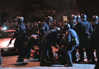 Oakland PD officers arrest protesters on Nov. 5, 2010. Screenshot via Youth Radio/YouTube.