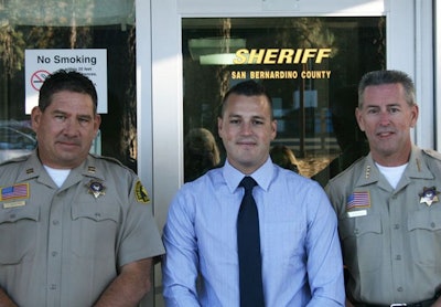 Deputy Alex Collins (center) is welcomed back by Capt. Tom Bradford (left) and Sheriff John McMahon. Photo courtesy of San Bernardino County.