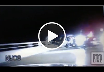 Michigan State Police dashcam video shows trooper following suspect over bridge railing.