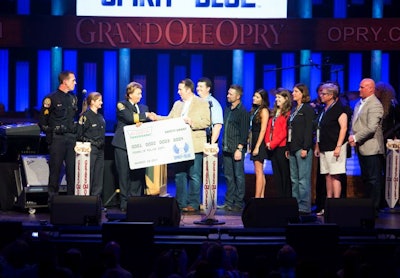 Franklin (Tenn.) PD Sgt. Brian Woodward, Officer Rachel Gober, and Chief Deb Faulkner (left to right) accepted the Spirit of Blue Safety Equipment Grant on the Grand Ole Opry stage, August 19th. The grant was presented by Spirit of Blue representatives Ryan T. Smith, Andrew Heltsley, Craig Morgan, Melissa Norrod, Kara Palm (Krispy Kreme Doughnuts), Sue Post, Diane Harbour, and Todd Parola. PHOTO: Chris Hollo for the Grand Ole Opry