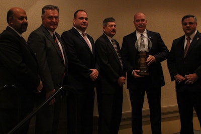 Members of the Missouri State Highway Patrol Rural Crimes Investigative Unit stand with their award, flanked by Chief Yousry 'Yost' Zakhary, IACP past president, left, and Dan DeSimone, senior director of Integrated Solutions & Business Development for Thomson Reuters.