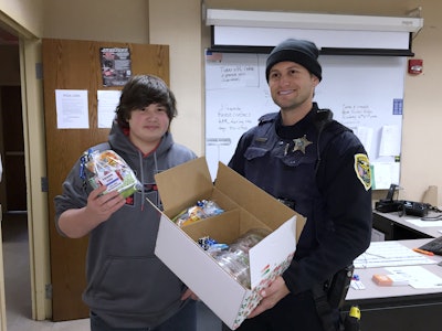 Zachary Witulski presents some gift packages to a Hammond, Ind., officer. (Photos: Mary Beth Witulski)