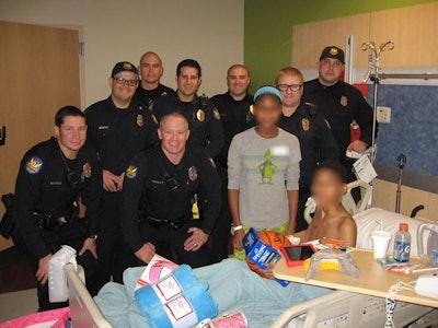 Phoenix officers presented children reportedly stabbed by their mother Christmas gifts. (Photo: Facebook)