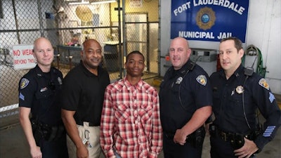 Jamal Rutledge (center) was commended for helping to save the life of Officer Franklin Foulks (second from left). Photo: Fort Lauderdale (Fla.) PD