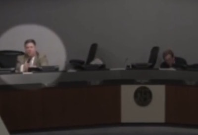 After yelling for his fellow council members to get down, former officer John Elder drew his handgun and prepared to respond if the shooter came in the council hall, (Photo: Screen Grab of video)
