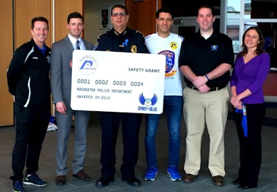 The Spirit of Blue Safety Equipment Grant will provide 8 ballistic vests to the Rochester (N.Y.) Police Department thanks to a generous donation from the Rochester Lancers professional soccer team. Attending the ceremony was (left to right) Doug Miller, Lancers' Head Coach; Rich Randall, Lancers' President; Chief Michael Ciminelli of the Rochester Police Department; Marcello Moreira, Lancers' Goalkeeper; Ryan T. Smith, Executive Director of the Spirit of Blue Foundation; and Amy Pierson, widow of slain officer Daryl Pierson.