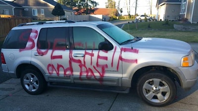 Vandals wrote 'sue cheif and pay' on Gerry Pickens' SUV before he filed suit against the city of Orting, Wash. The crime is still under investigation. (Photo: Orting PD)