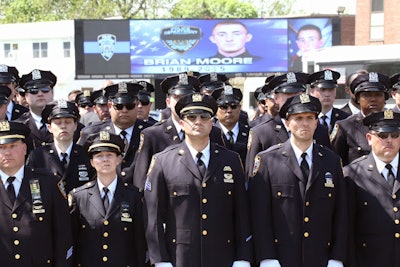 NYPD officers pay respects to their fallen comrade Brian Moore. (Photo: NYPD)