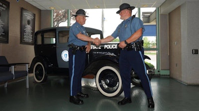 State troopers Philip Kucha, right, and Al Balestra meet again after Balestra rescued an ill Kucha when he was an infant in 1983. (Photo: Massachusetts State Police)