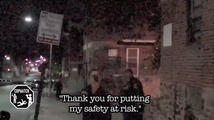 Baltimore officer uses cellphone to video 'cop-watcher' videoing officers. (Photo: Screen shot from Baltimore Sun video)