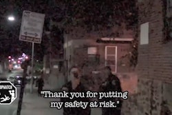Baltimore officer uses cellphone to video 'cop-watcher' videoing officers. (Photo: Screen shot from Baltimore Sun video)