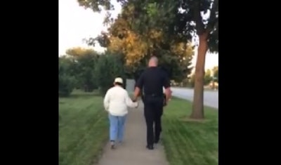 Bloomingdale officer walking with mentally disabled woman. (Photo: Facebook)