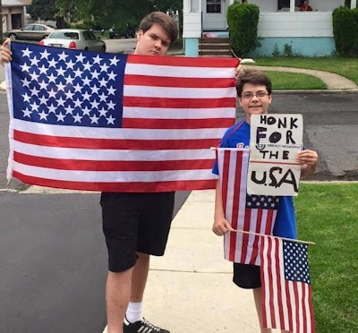 Shpejtim Zenelaj (right), 14, posed with his sign, along with his cousin Gezim Berisha, 16 (left). (Photo: Shpejtim Zenelaj )