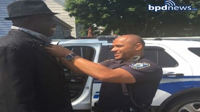 Officer ties man's necktie so he can go to church. (Photo: Boston PD)