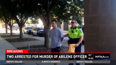 Suspect Philip Walter escorted by Abilene officer. (Photo: WFAA screen shot)