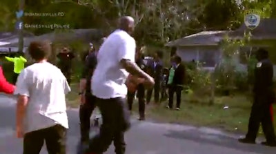 Shaquille O'Neal joined Gainesville, FL, officers to play basketball with local kids. (Photo: Screen shot from WJXT TV)