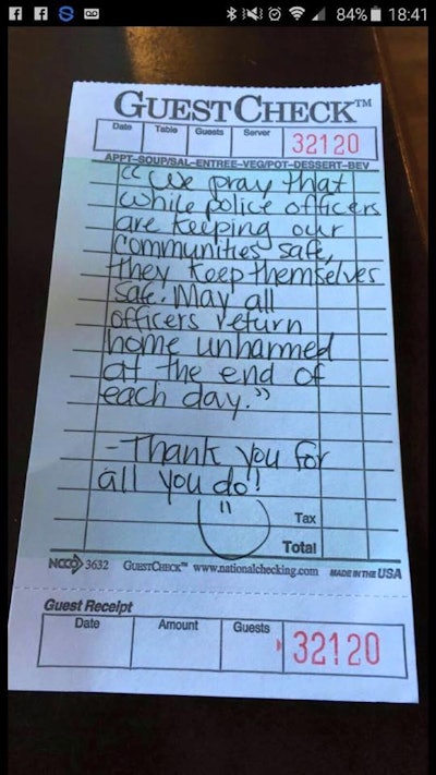 An unknown customer paid the officers' check and left this note. (Photo: Facebook)