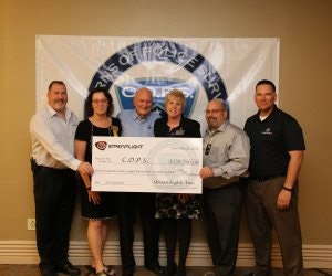 Streamlight employees present a check to representatives of Concerns of Police Survivors, including National President Brenda Donner (second from left) and Dianne Bernhard, the organization's Executive Director. (Photo: Streamlight)