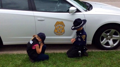 The Indianapolis Metropolitan Police Department posted a photo on Facebook of an officer's children praying for their father's safe return. (Photo: Facebook)