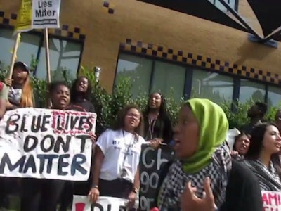 Black Lives Matter protesters at UC Irvine hold protest signs attacking police. (Photo: Facebook)