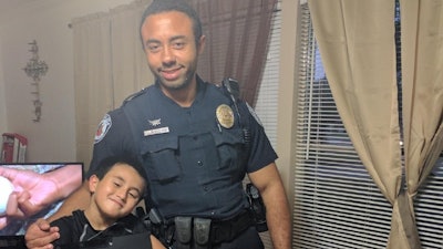 Officer Brandon Smith with Aidan Munro. (Photo: Seguin PD)