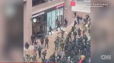 Rioters smash store windows during Trump inauguration protests in Washington, DC. (Photo: Screen shot from CNN video)
