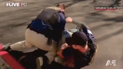 A&E's 'Live PD' shows real-time video of officers on duty like this scene of Tulsa gang officers grappling with a suspect. (Photo: Screen shot from A&E video on Youtube)